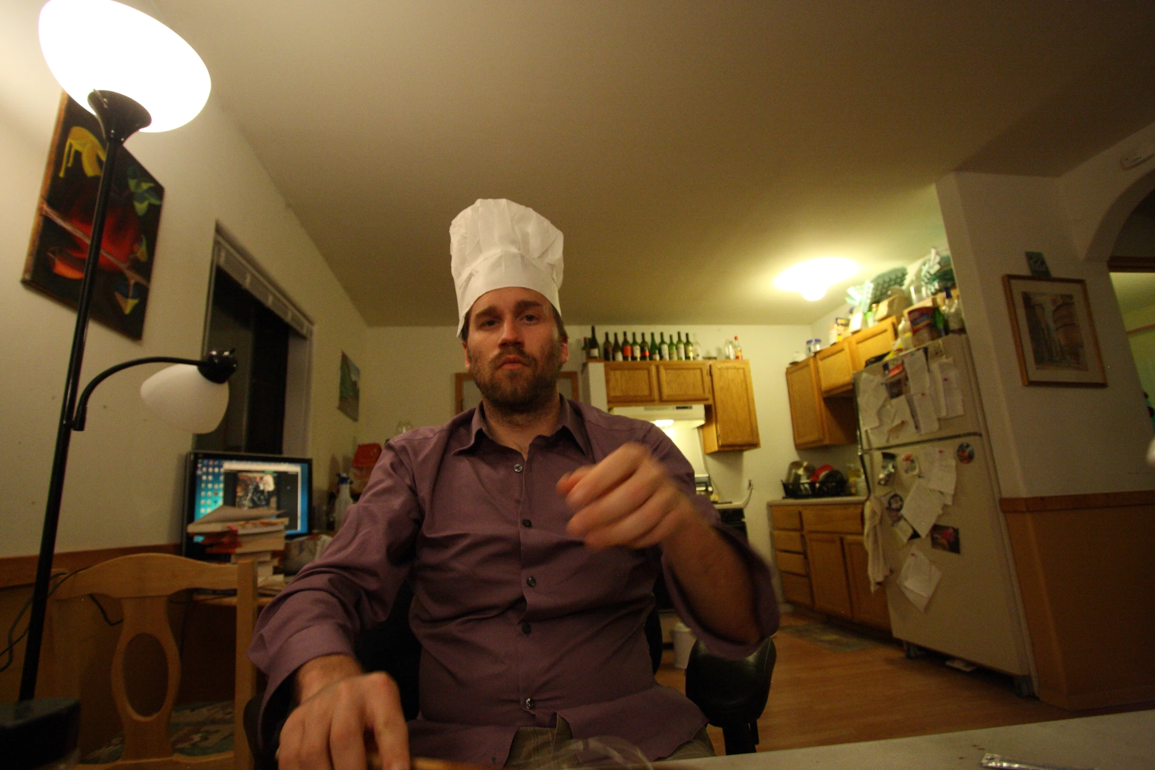 a man sitting at a table with some food on top of it