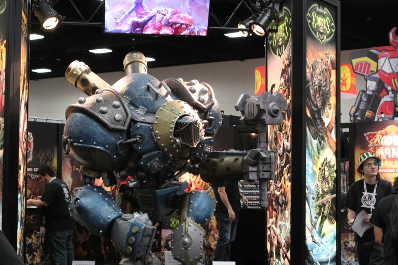 an exhibit with a big metal robot sculpture on display