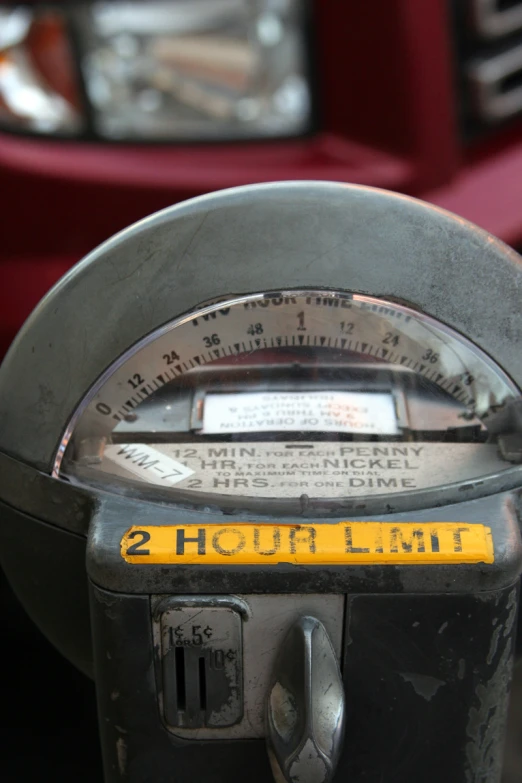 a parking meter showing the time at which it is 12 pm