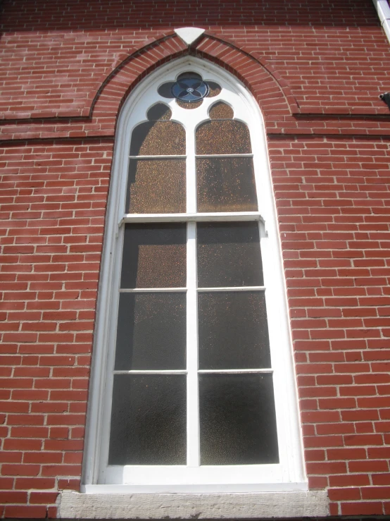 the arched window is reflecting the side of a building