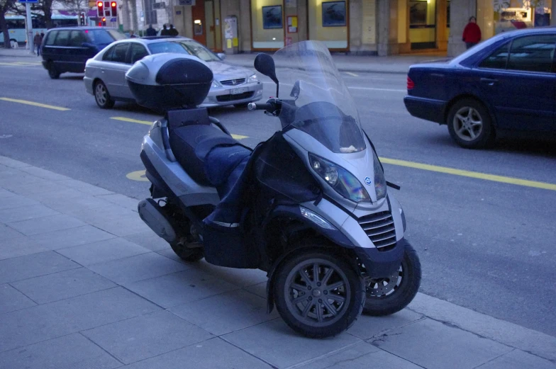 there is a motorcycle on the road next to a car