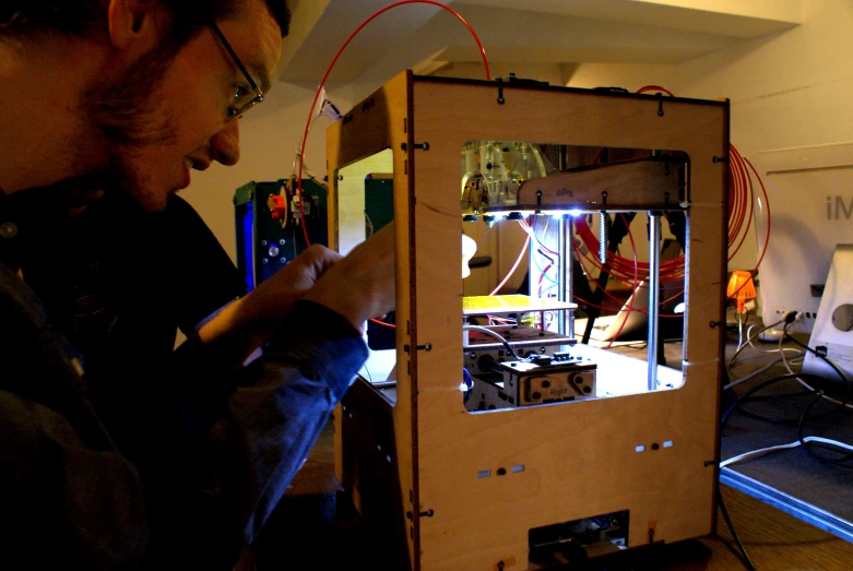 a man uses some wires to work on his model