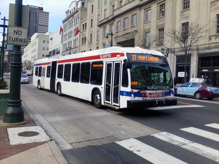 the bus is driving through the intersection of the city street