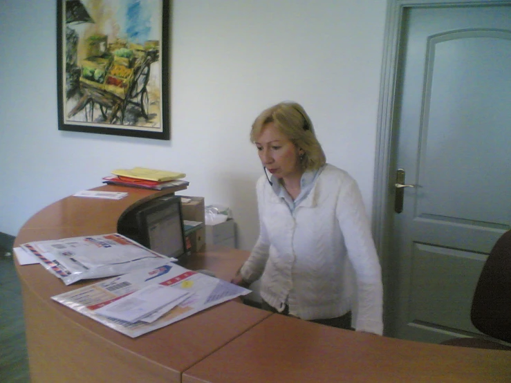 a woman talking on her phone at an office desk