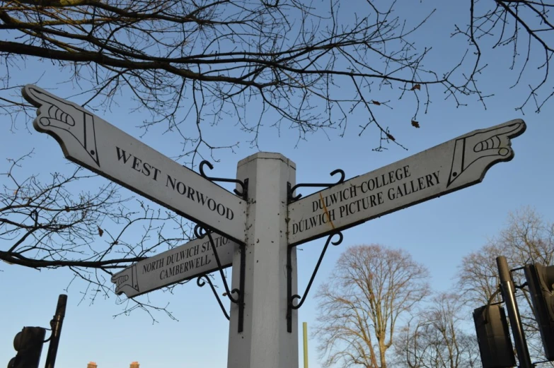 a street sign showing the directions to different towns