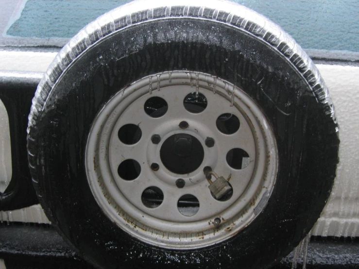 a white car tire with small holes that allow more space for the wheels