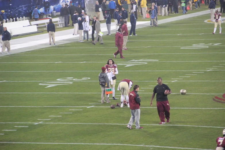 some fans and a man are playing on a field