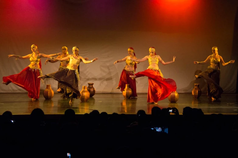 group of girls dancing on stage, with lights on