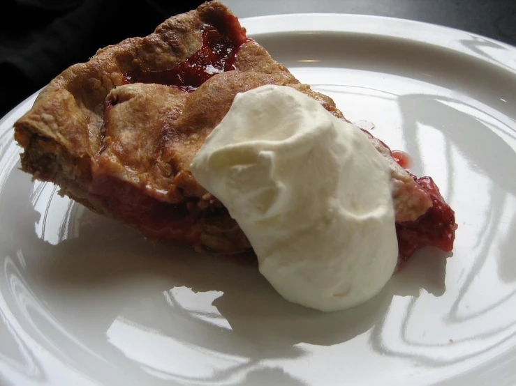 a piece of pie with whipped cream on top