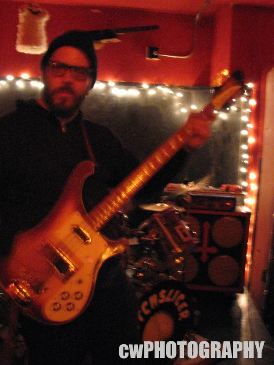 two men are standing in front of a mirror with a guitar