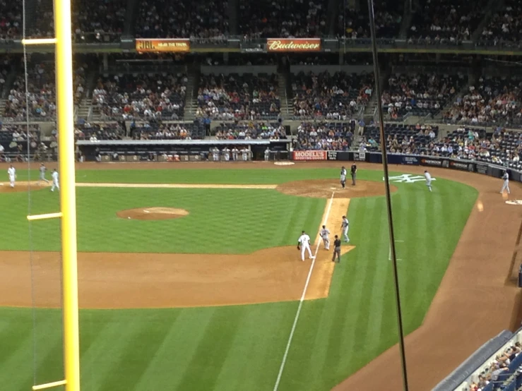 a baseball game in progress with the batter about to swing at the ball