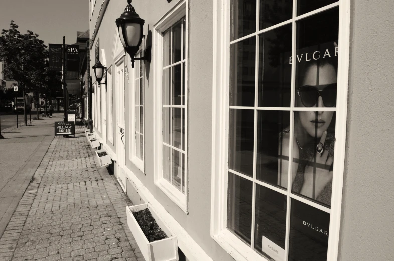 a black and white image of a store window with the word eyeglasses on it