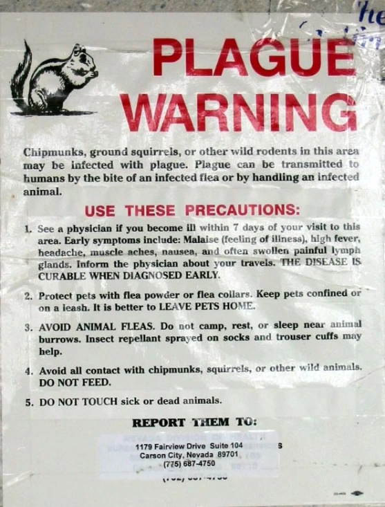 a warning sign posted on a wall near a door