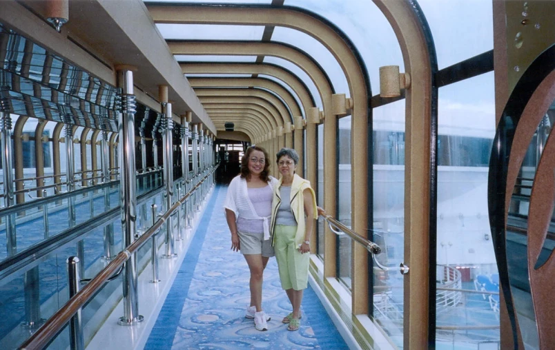 two women walking down the hallway on a ship