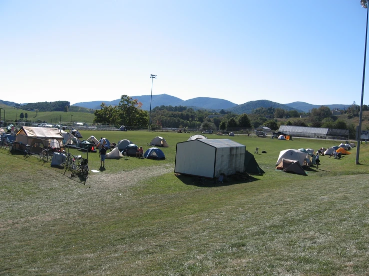 a field with several tents set up on top of it