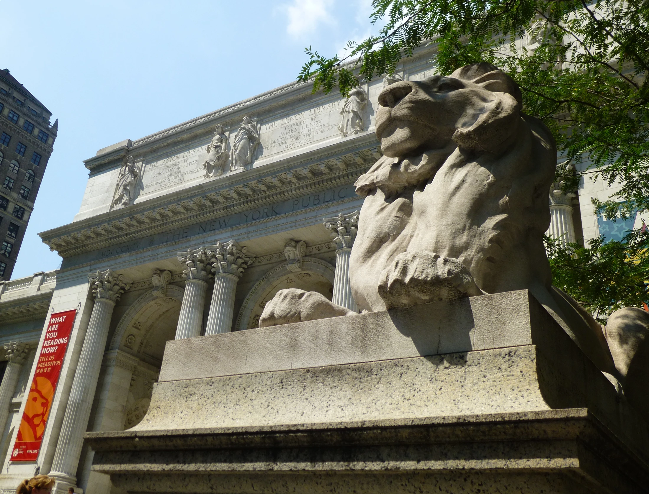 an architectural stone fountain with the faces of a lion on it