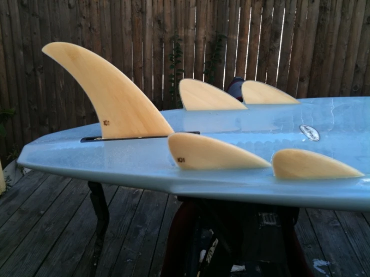 a close up of three surfboards on a table