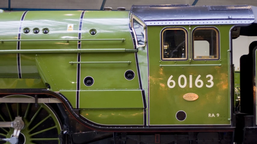 an old green train car that is painted green