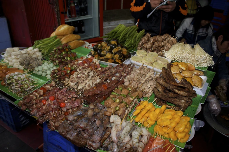 various foods and vegetables on display at an outdoor market