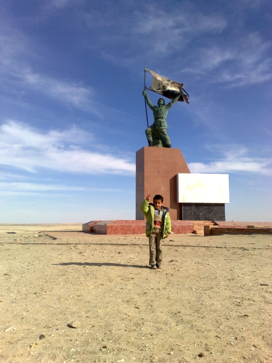 a man in a backpack is standing in front of a statue