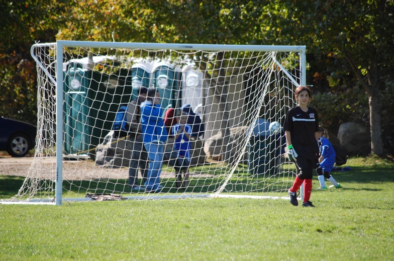 a soccer goalie trying to block the soccer ball