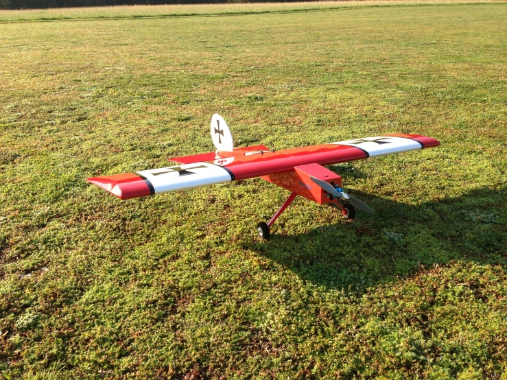 a toy airplane on wheels sitting on the ground