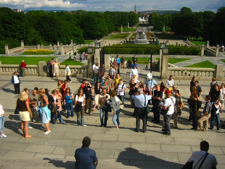 many people on the stairs of the city park