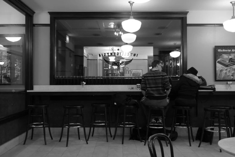 a black and white po of a couple at the bar