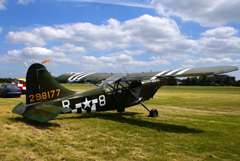 the fighter plane is parked in a grassy field