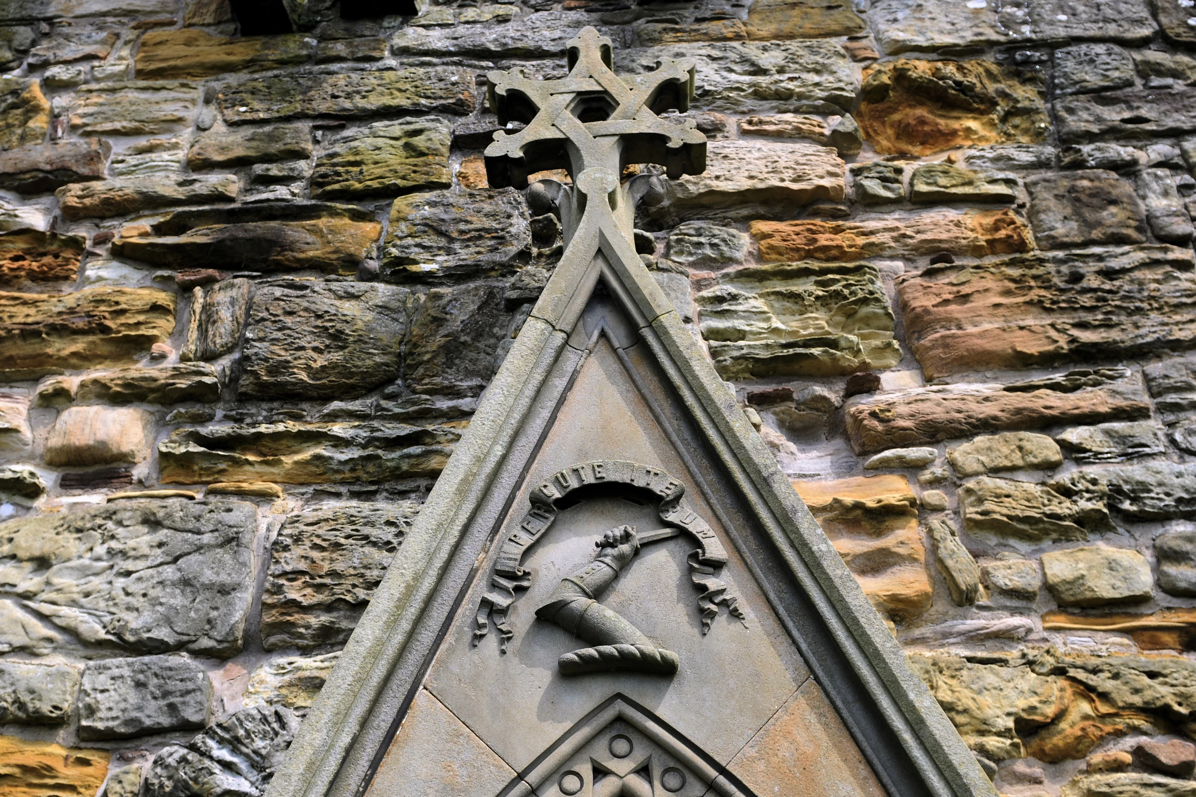 there is a cross on the side of a brick building