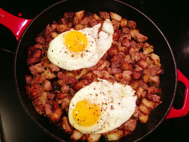 two fried eggs are in a set with sausage