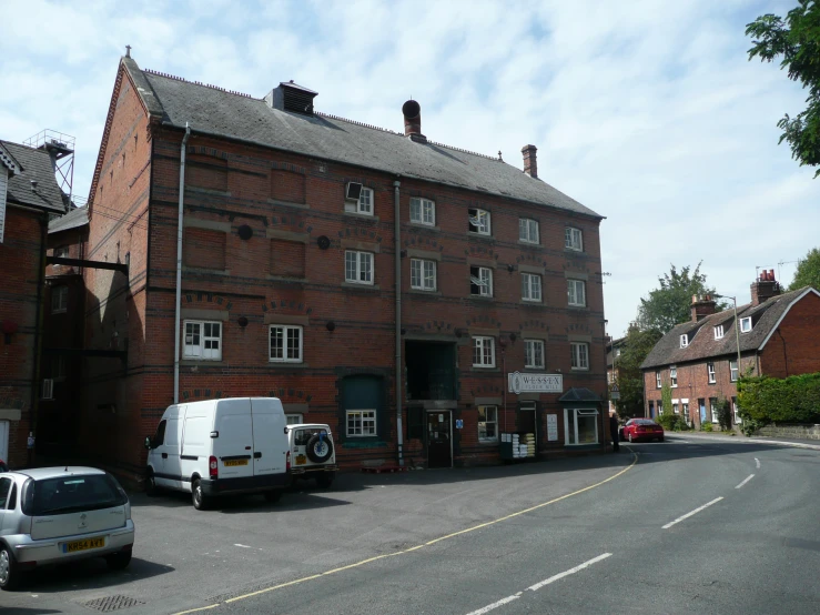 a street scene with an old brick building with several windows