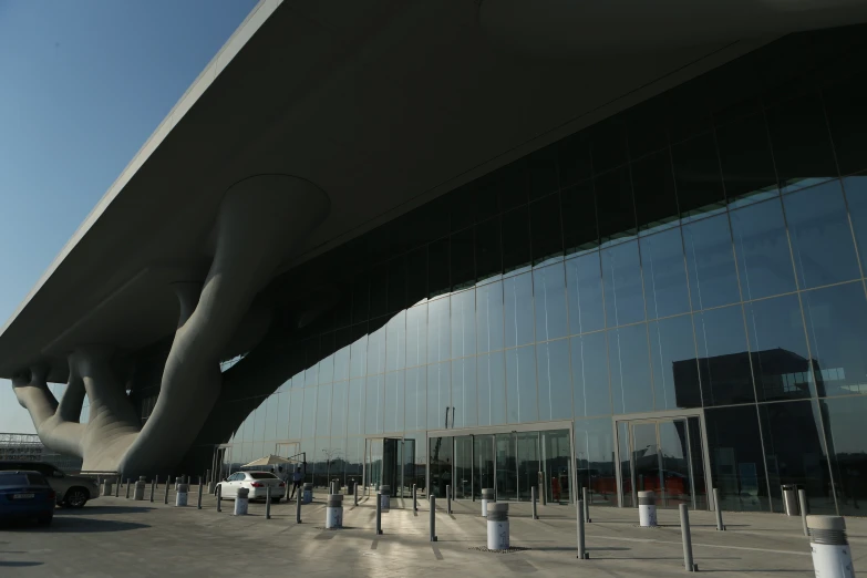 an airplane hanger next to a large glass building