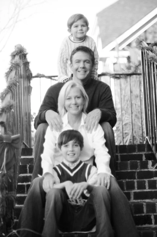 a black and white po of four people on stairs