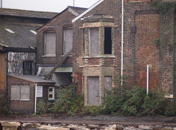 an old run down brick building with a broken window