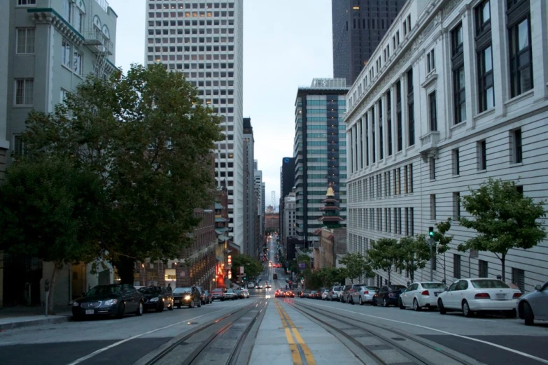 a city street is empty with cars on both sides
