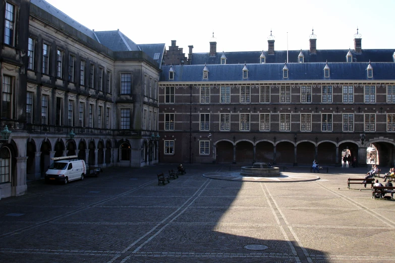 a group of people are sitting in a courtyard