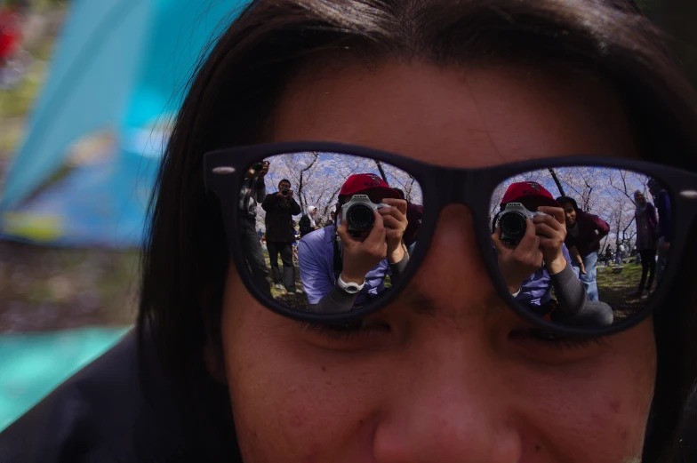 a person with sunglasses on taking a picture