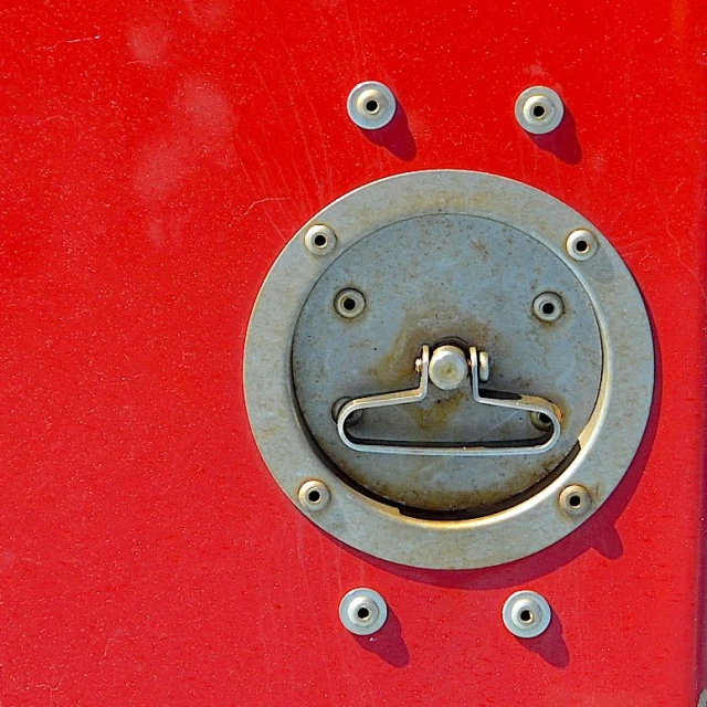the door latch on a red truck is empty