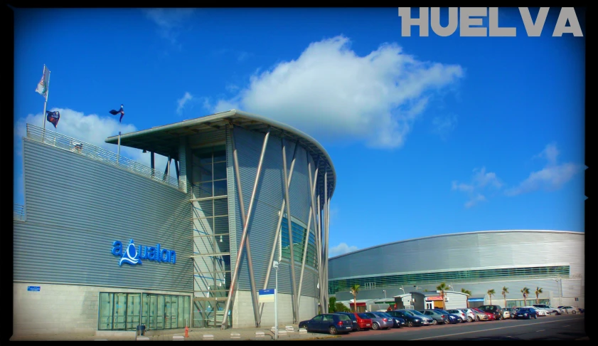 an architectural building with cars parked outside