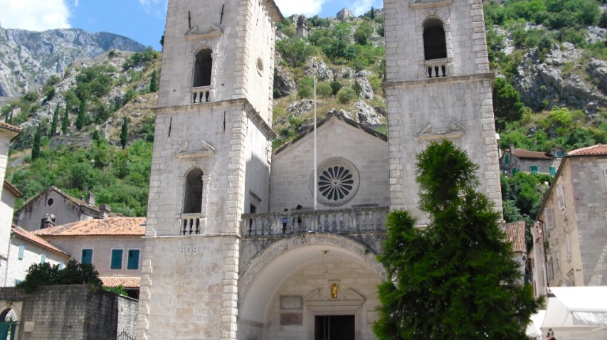 a church sitting on top of a hill in a small town