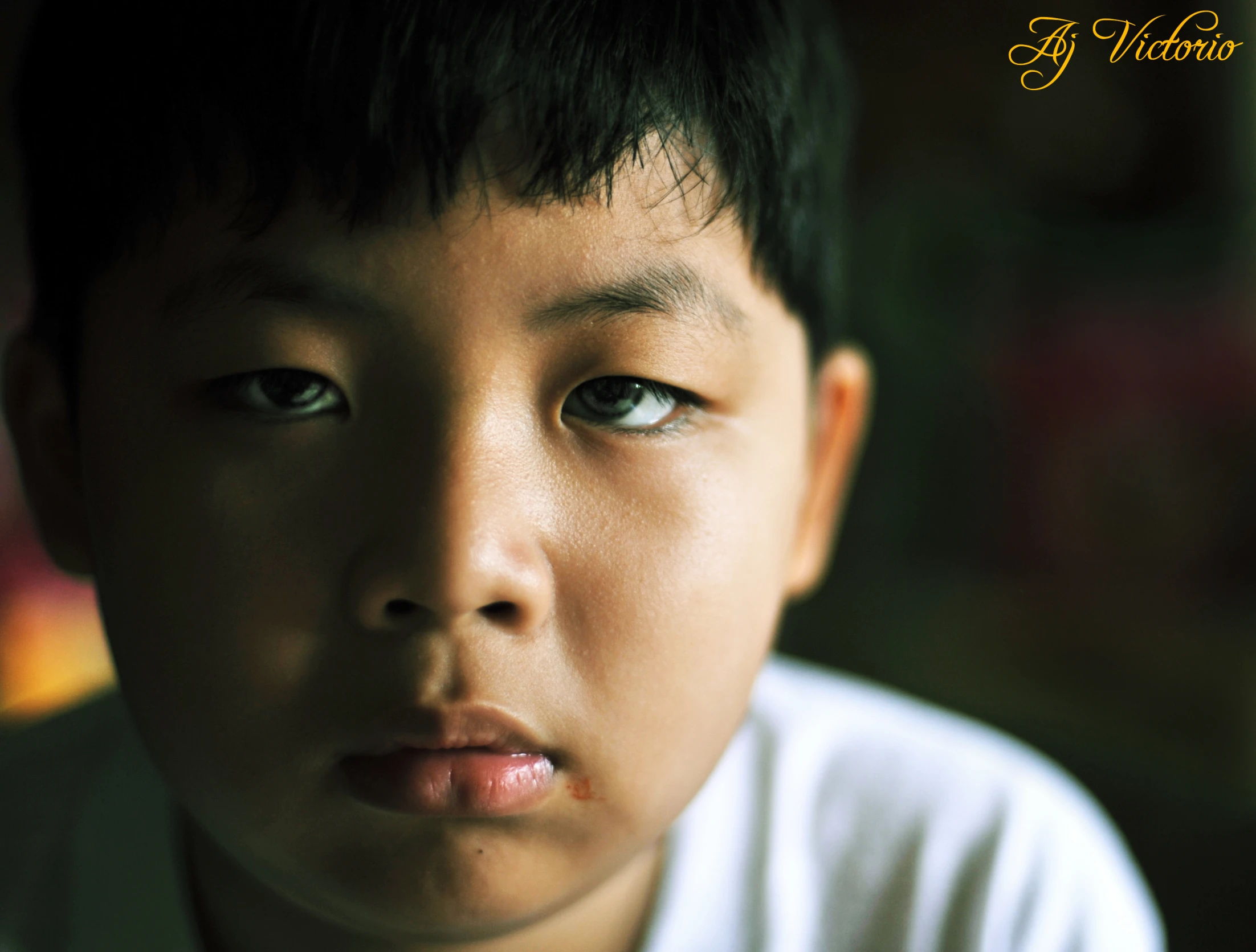 a young child with a white shirt and a black hair