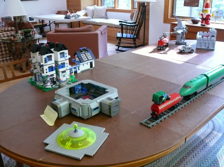 a living room and dining room area are in the shape of a train set