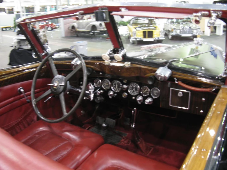 the inside of a car with two red leather seats and dashboard