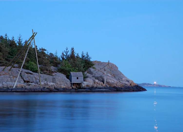 the boat house is sitting on the water