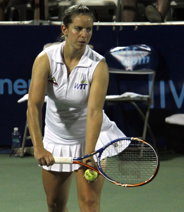 a woman standing on top of a tennis court with racquet