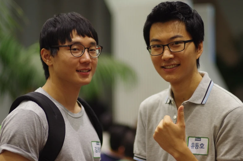 two asian men smiling and posing for the camera
