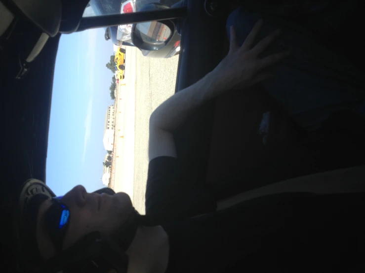 man sitting in passenger seat of airplane on runway