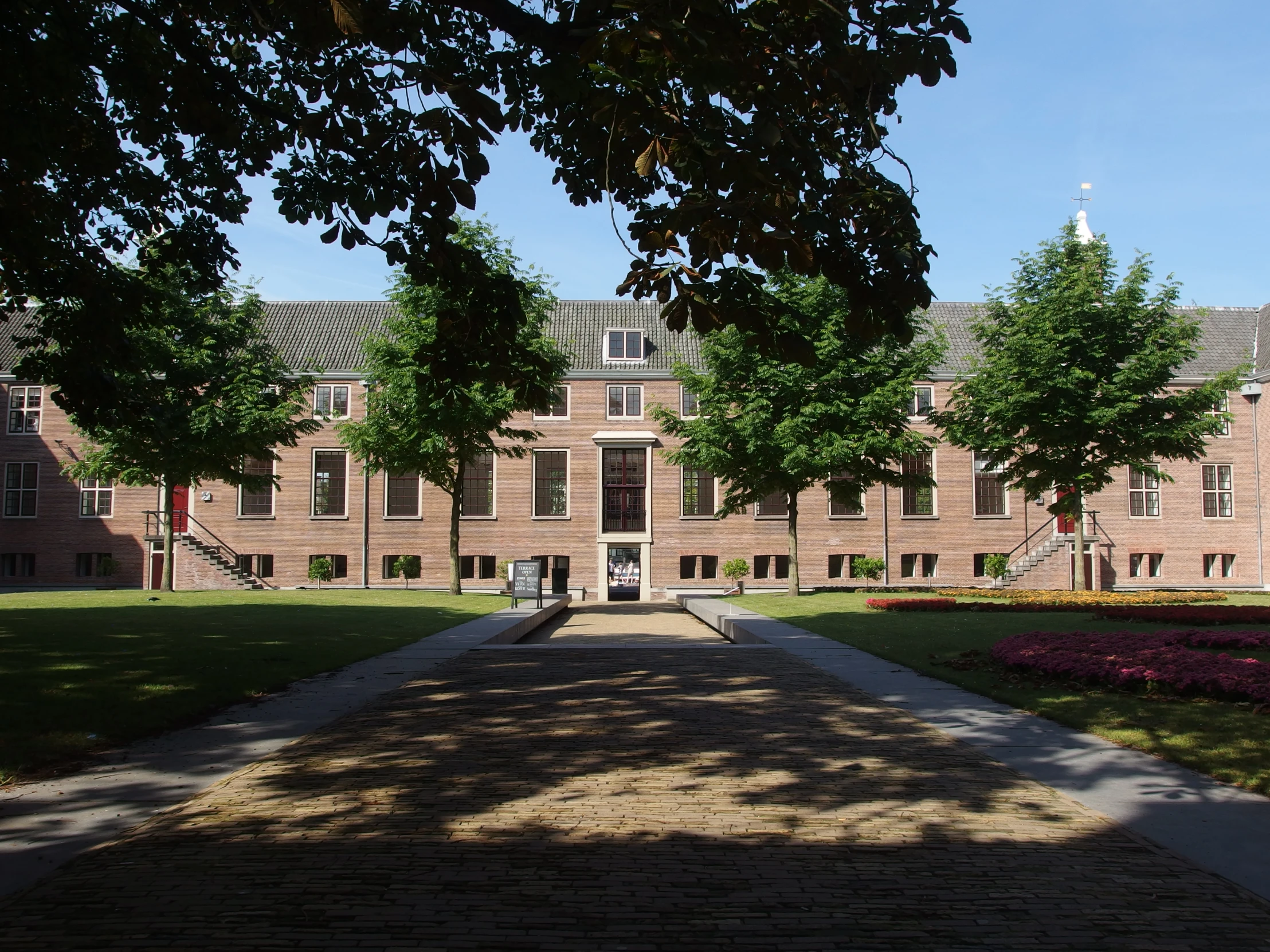 view of a path in front of a large brick building