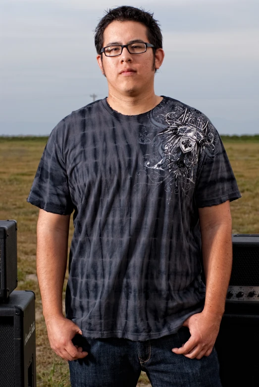 a man standing in front of several speakers